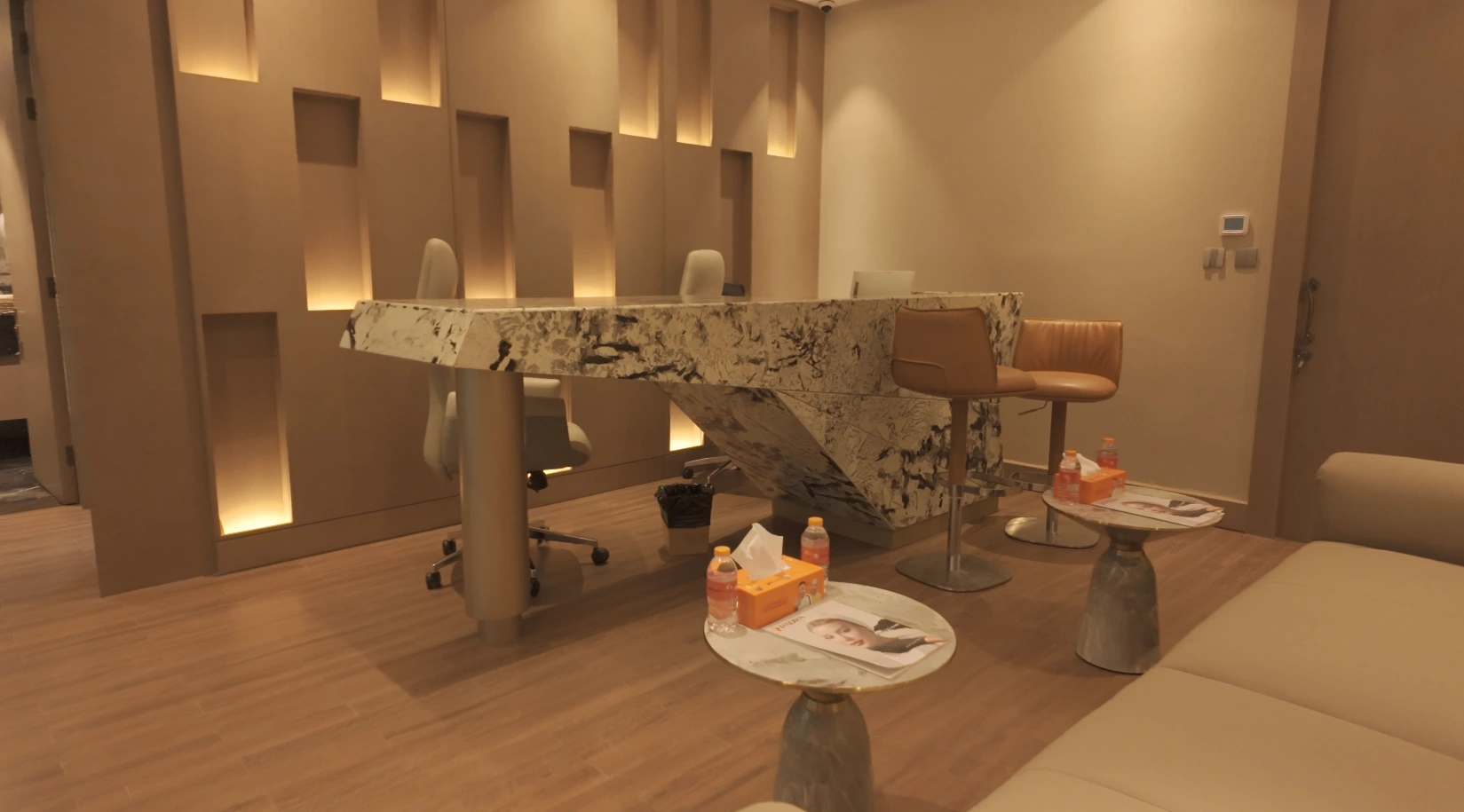 Modern patient reception area with a marble desk at Padra Clinic in Qatar