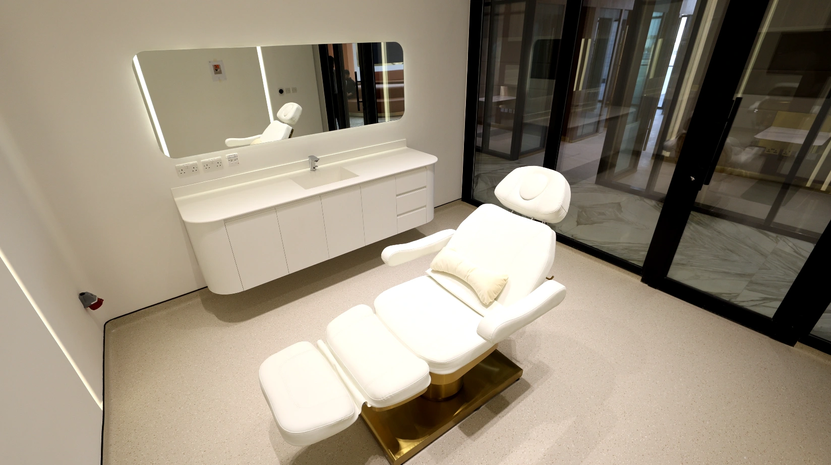 Private cosmetic treatment room with an adjustable chair at Padra Clinic